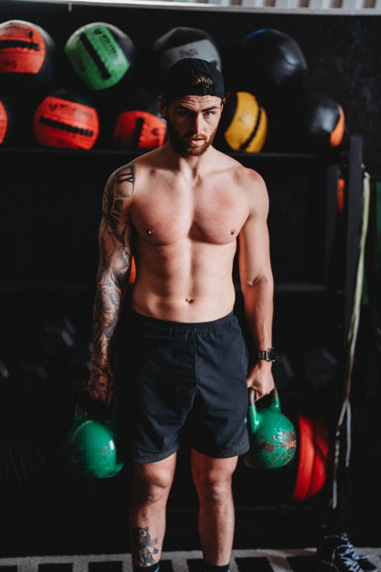 Chris Terry performing a static hold with kettlbells