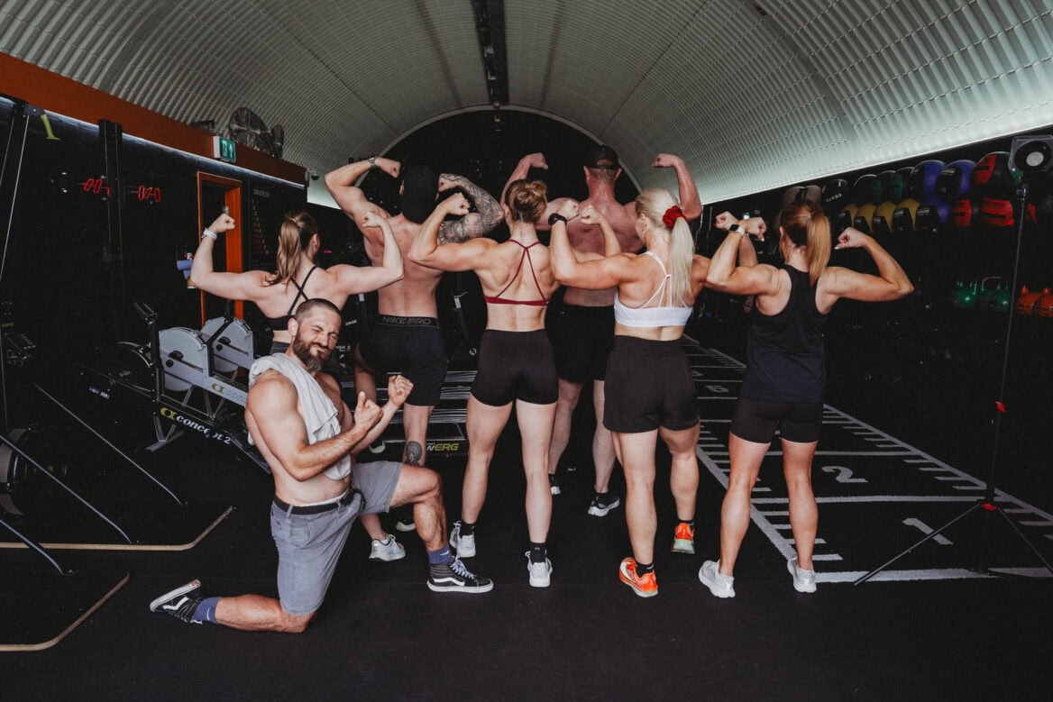 RZLT Training staff striking a rear double bicep pose